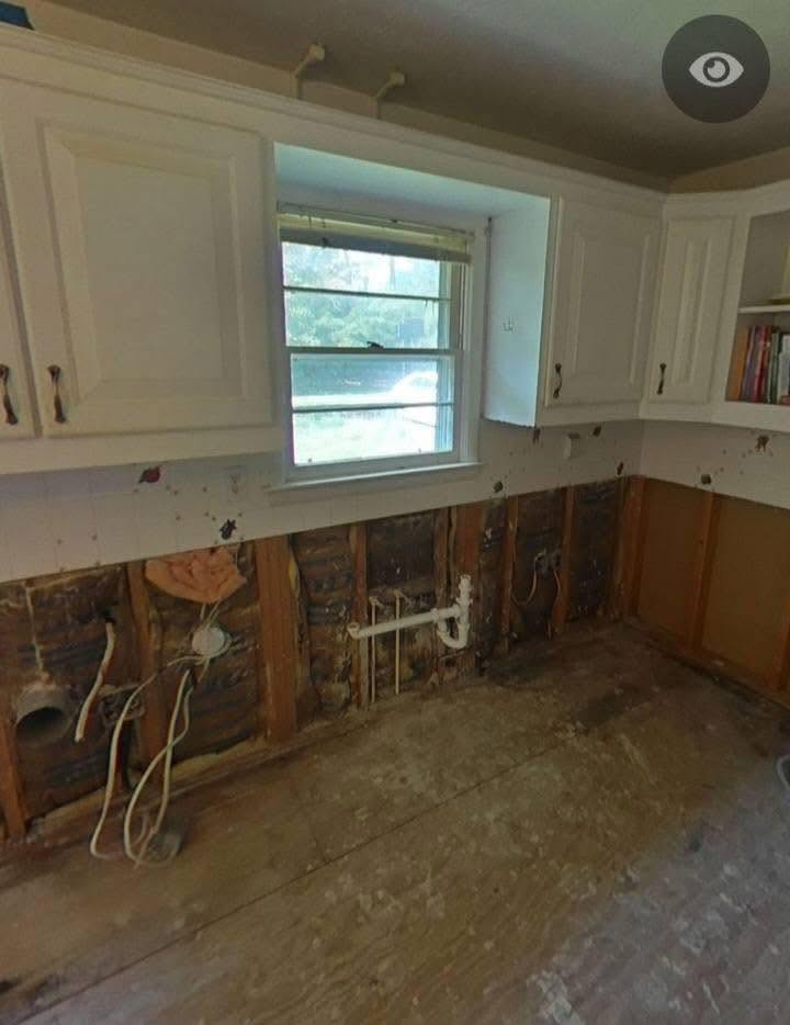 Interior water damage restoration with drywall removed down to the studs