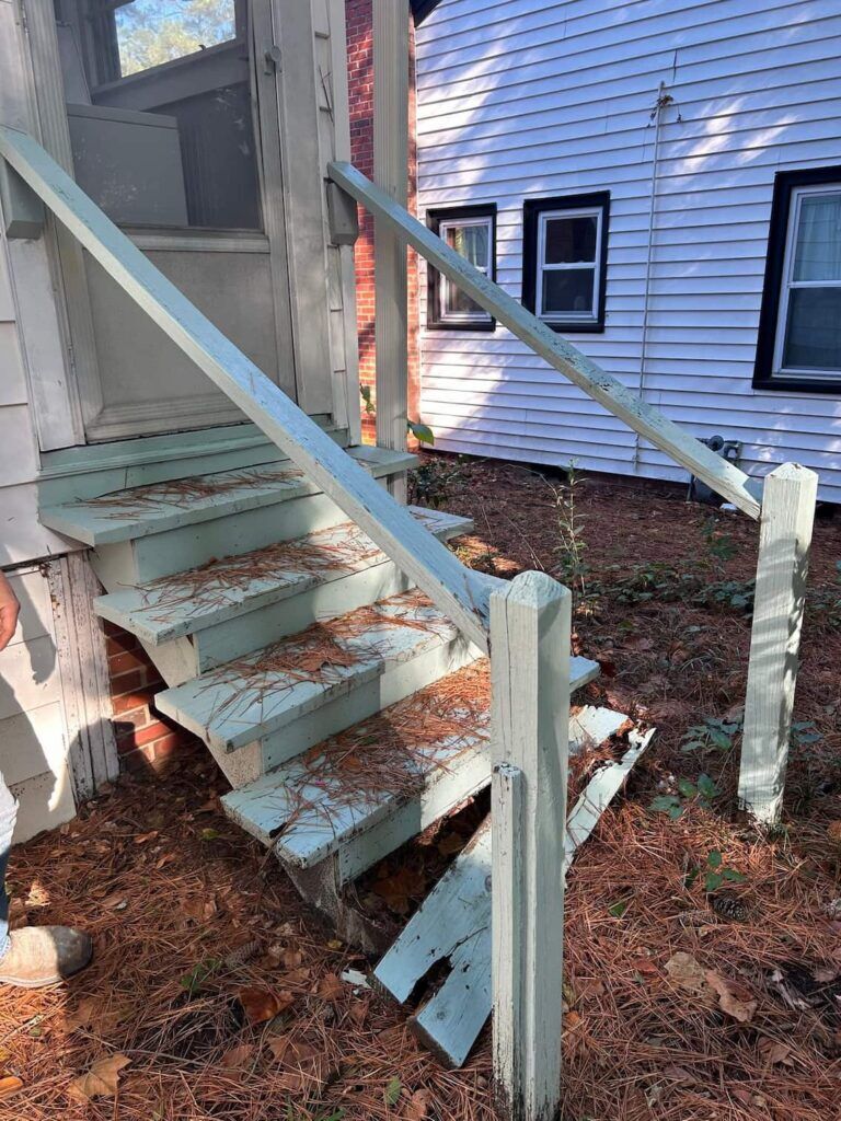 Deteriorated wooden deck stairs before replacement